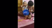 Father uses carrier bag as harness to help baby learn to walk