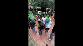 Anti-corruption protesters throw police equipment into  water