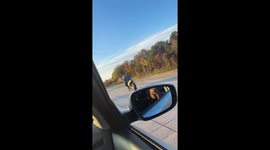 Motorcycle rider performs road trick in Greensboro, North Carolina, USA