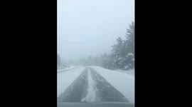 Snow-covered road conditions in Randolph, New Hampshire, USA
