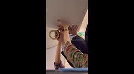 Cabin crew use tape to fix water leak from overhead compartment on flight