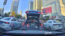 Car's boot opens as unaware motorist speeds off leaving trail of possessions on road