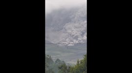 Ash cloud engulfs hillside as volcano erupts in Indonesia