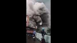 Volcano eruption ash cloud engulfs bridge as locals run to safety in Indonesia