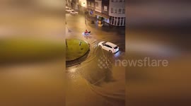 Motorcycle rider struggles through flooded streets in Brazil