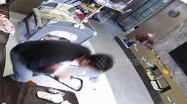 Father nearly drops young child while retrieving phone
