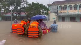Police officers wade through flood to send pregnant woman to hospital