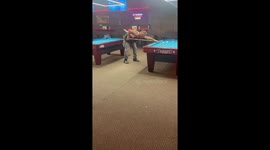 Man plays billiards with toddler on his back in Minnesota, USA