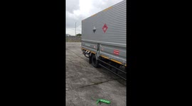 Mechanic works on truck engine compartment
