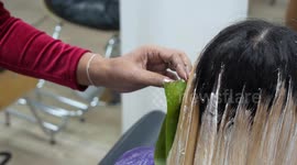 Creative hairdresser uses giant banana leaves to style clients' hair