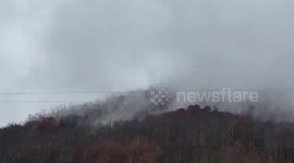 Thick fog settles over rainy hillside in Gray, Kentucky, USA