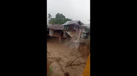 seconds before a house collapsed into a river due to a landslide in Indonesia