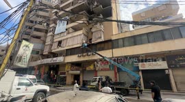 Civil defense teams remove debris after Israel's overnight strikes in southern Beirut
