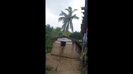 Terrified locals hide inside during firefight between communist rebels and the military