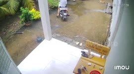 Rider falls into gutter as scooter slips on wet algae in Gò Công, Vietnam