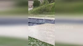 Hailstones make a splash as they land in backyard pool in Brazil