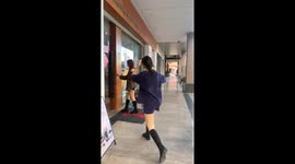 Woman slips on doormat during playful door-opening joke in Guangdong, China