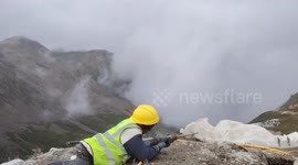 Construction worker humorously imitates gunfire with electric drill Xizang, China