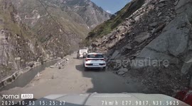 Boulder Falls Across Car Hood On Mountain Road