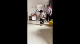 Toddler wobbles across floor as he tries on mum's high heels