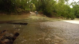 Philippines: Local used raft to cross river after damage of detour due to heavy flooding