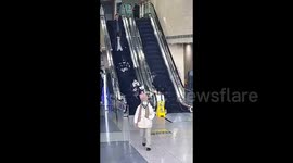 Elderly man loses balance on escalator but is caught by passing police volunteer