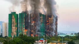 Fire engulfs Hong Kong tower blocks, killing at least 13
