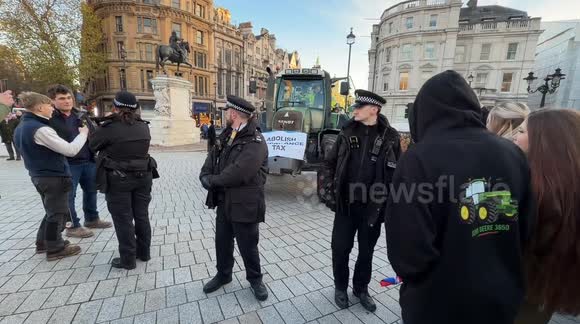 Police officers seize a tractor. Farmers are protesting near Trafalgar Square and Westminster on Budget Day, bringing tractors into central London despite a police ban. The demonstration targets proposed changes by the government to agricultural property