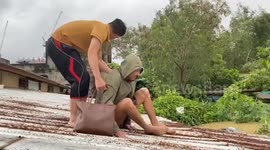 Rescue teams battle raging floods to save villagers stranded on roofs in southern Thailand