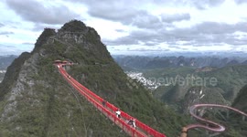 DRONE - China’s Ruyi Peak attracts tourists with transparent bridges, elevated paths