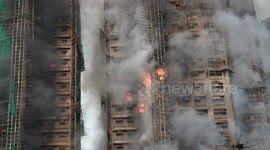 UNCAPTIONED. At Least Four Dead as Massive Fire Engulfs Hong Kong High-Rise Complex