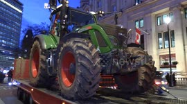 Police impound a tractor in Trafalgar Square and tow it away during budget day farmer protests.