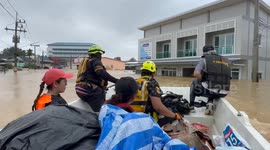 Rescuers row through submerged neighbourhoods to save residents stranded in flood