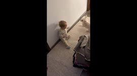 Baby laughs while playful dog runs around in Iași, Romania