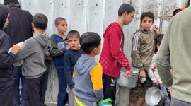 Displaced families in Deir al-Balah wait hours for food amid deepening hunger in Gaza