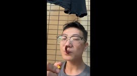 Man attempts to smoke a chili pepper and starts coughing in Guangdong, China