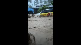 Cars swept away as floods surge through homes in Indonesia