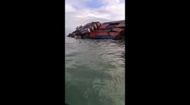 Container ship struck by storm capsizes off coast of Indonesia