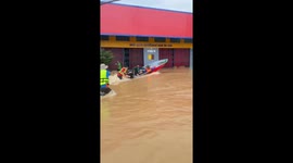 Rescue boat struggles with the force of flood in Thailand