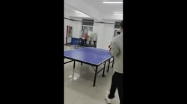 Friends share laughter during playful ping pong trick in Jiangxi, China