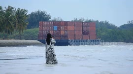 A container barge is stranded in Port Dickson waters near a resort hotel area after being swept away by sea waves following tropical storm Senyar