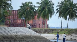 A container barge is stranded in Port Dickson waters near a resort hotel area after being swept away by sea waves following tropical storm Senyar