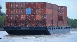 A container barge is stranded in Port Dickson waters near a resort hotel area after being swept away by sea waves following tropical storm Senyar