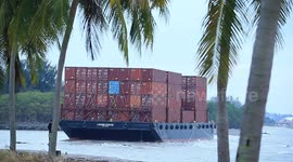 A container barge is stranded in Port Dickson waters near a resort hotel area after being swept away by sea waves following tropical storm Senyar