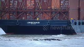 A container barge is stranded in Port Dickson waters near a resort hotel area after being swept away by sea waves following tropical storm Senyar