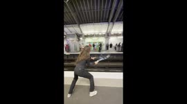 Commuters play casual tennis while waiting for train in Paris, France