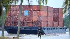 A container barge is stranded in Port Dickson waters near a resort hotel area after being swept away by sea waves following tropical storm Senyar