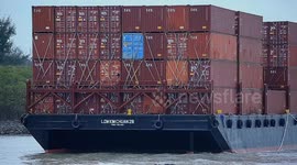 Malaysia: A container barge is stranded in Port Dickson waters near a resort hotel area after being swept away by sea waves following tropical storm Senyar