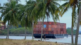 Malaysia: A container barge is stranded in Port Dickson waters near a resort hotel area after being swept away by sea waves following tropical storm Senyar
