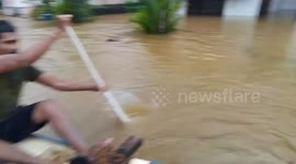Men rescue stranded dog during severe flooding in Ratnapura, Sri Lanka